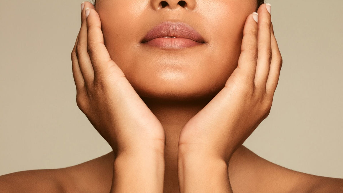 Close up of woman's face glowing after using a copper peptide serum