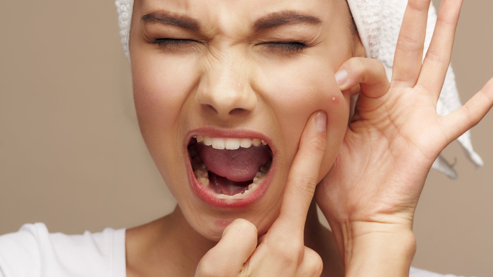 Woman busting a pimple