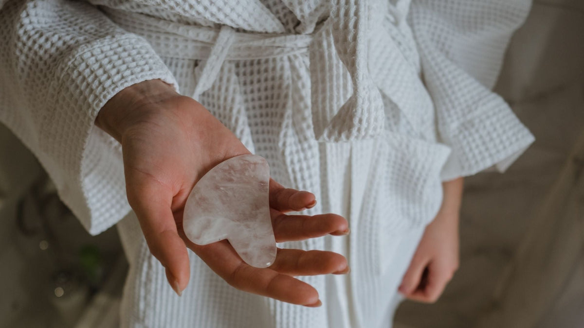 Woman holding a Gua sha tool