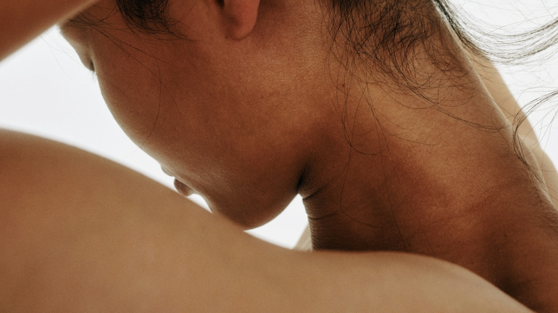 Close-up of a woman’s neck and shoulder.