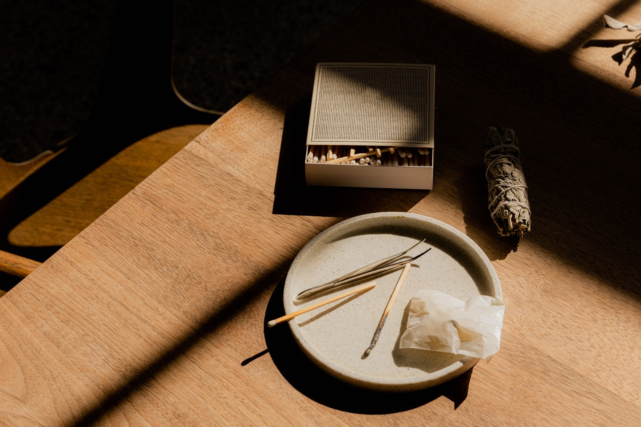 Mindful ritual scene with incense, crystal, and sage bathed in golden afternoon light.