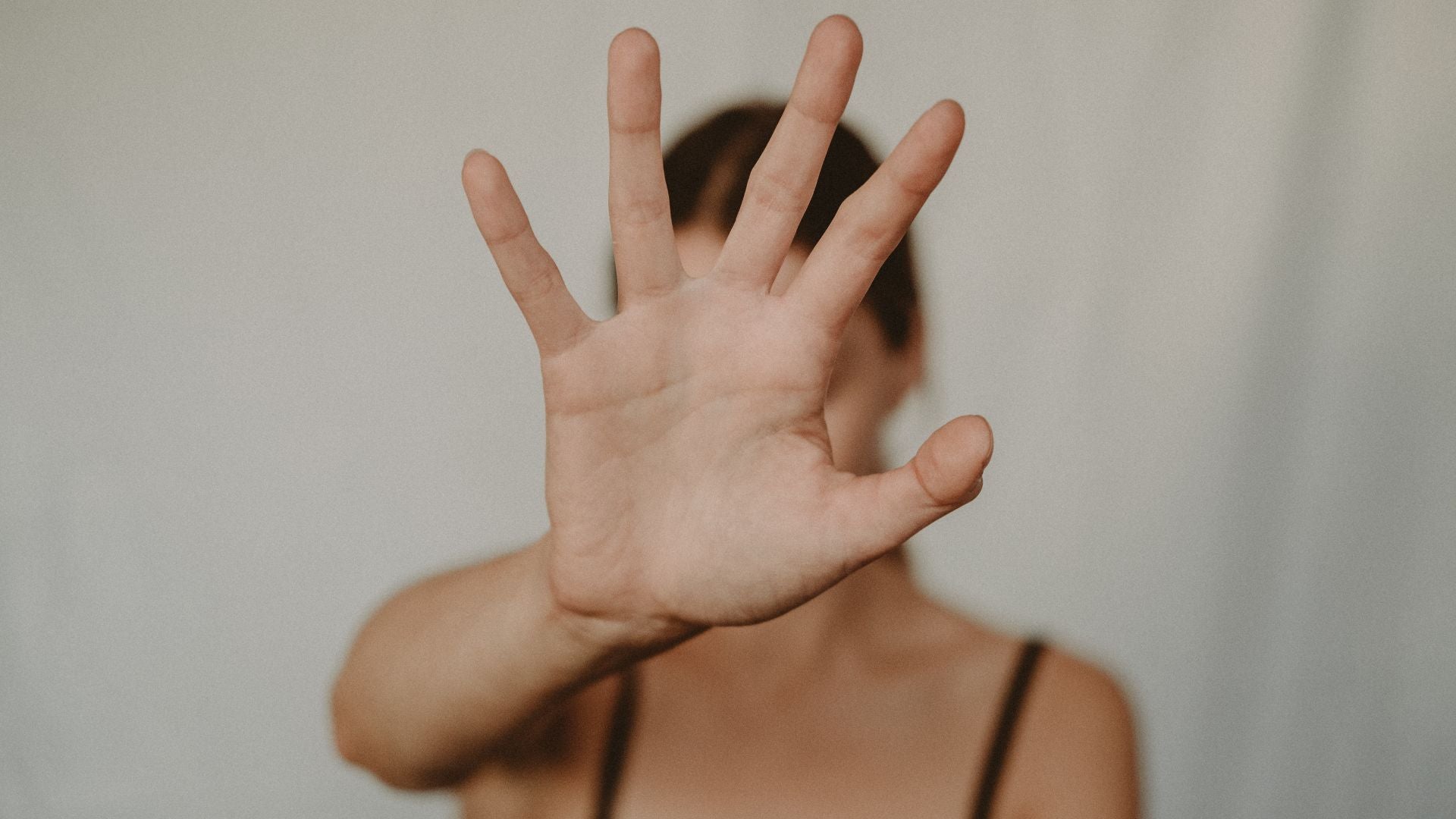 Woman with her hand up saying stop